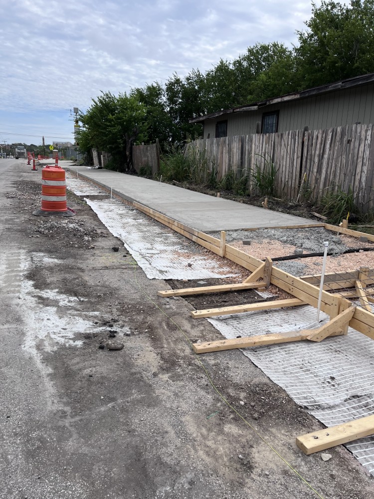 Sidewalk and driveway approaches' concrete pouring along the eastside of Memorial St. - North view